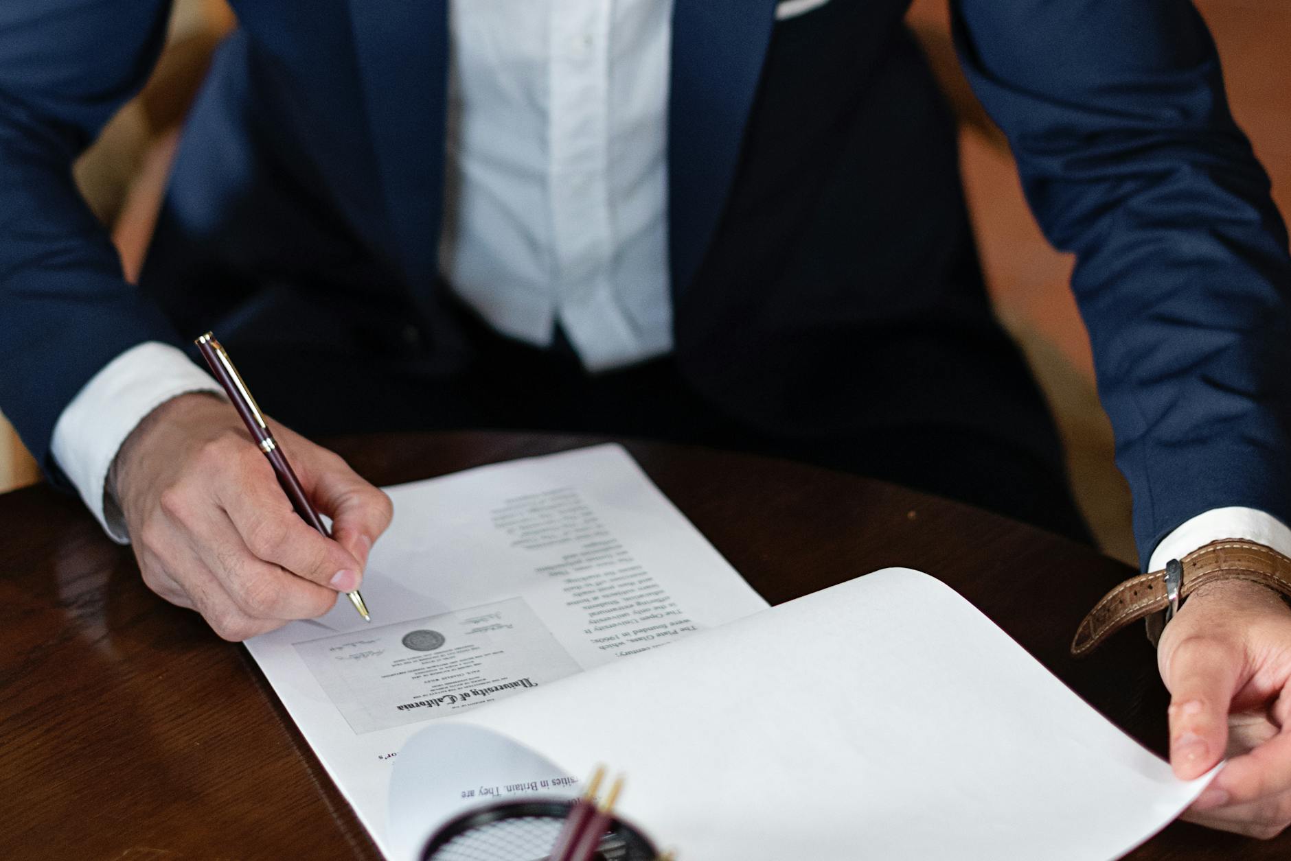 Photo by Mikhail Nilov on <a href="https://www.pexels.com/photo/elegant-man-signing-documents-8730998/" rel="nofollow">Pexels.com</a>