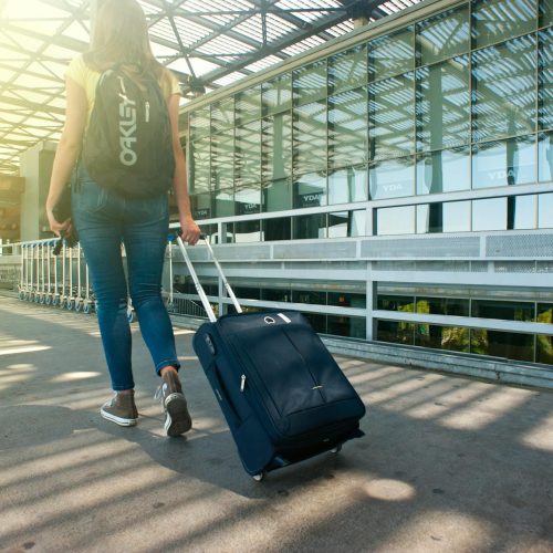 Photo by Alex P on <a href="https://www.pexels.com/photo/woman-walking-on-pathway-while-strolling-luggage-1008155/" rel="nofollow">Pexels.com</a>